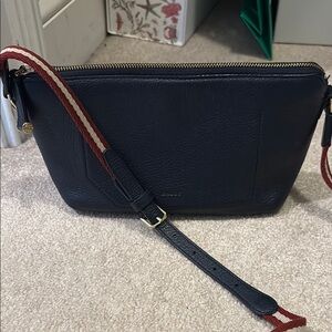 Black and Red Crossbody Bag with Adjustable Strap and Zipper Closure